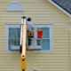 Man painting vinyl siding.